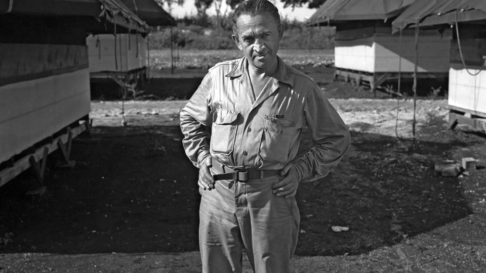 William L. "Atomic Bill" Laurence standing with hands on hips at Tinian Island in the Pacific, the launching point for the atomic bomb attacks against Hiroshima and Nagasaki
