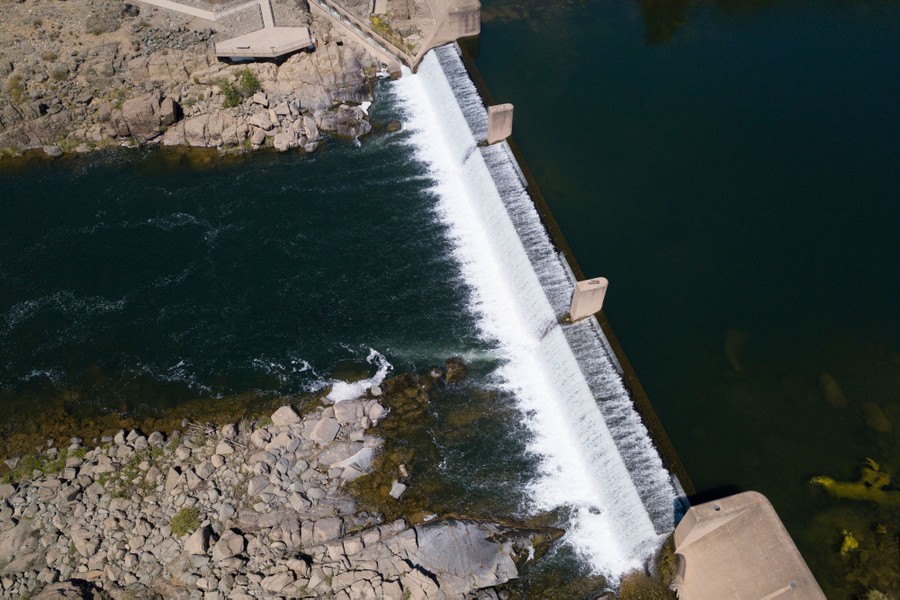 Water spills over a dam.