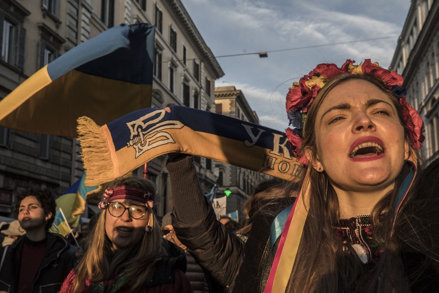 A crowd of protesters march in a city street.