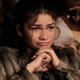 Zendaya with a concerned expression sitting in a school theater in "Euphoria"