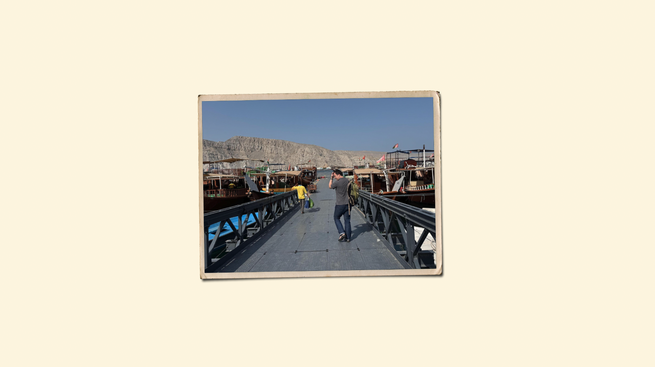 An illustration of a printed photograph of the author walking on a marina in the Strait of Hormuz