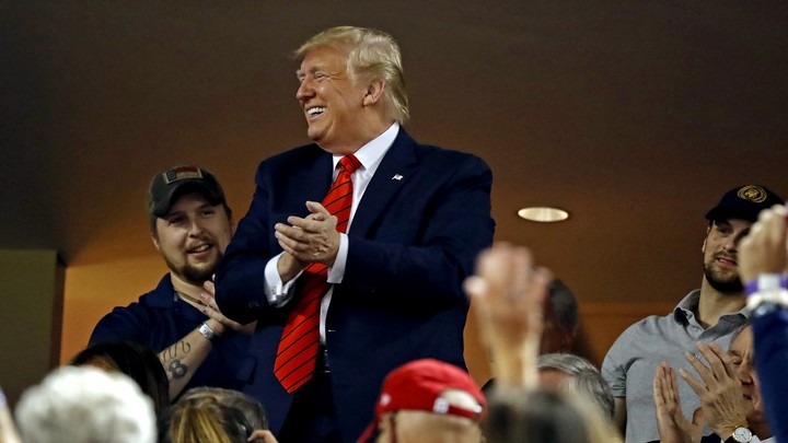 President Donald Trump waves to the crowd during Game 5 of the 2019 World Series.