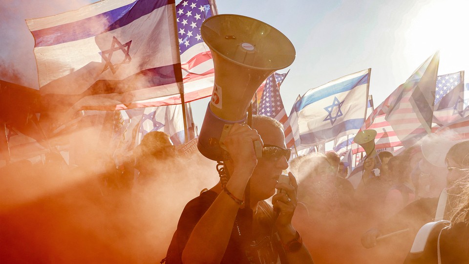 A photo of a man with a bullhorn at a protest of the Israeli government's judicial-overhaul bill
