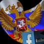 A Russian flag is seen next to the Facebook logo