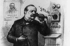 A black and white etching of President-elect Grover Cleveland holding a telephone to his ear. On the wall is a portrait of President Chester A. Arthur captioned, 'Pres. of U.S. till March 4, 1885.' The words "SPEAK OUT" are emanating from the telephone speaker in the wall.