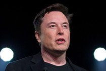 A close-up shot of Elon Musk against a dark background