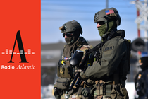 two federal agents with covered faces