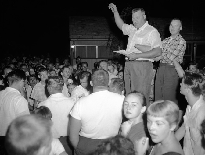 Residents of Levittown, Penn., are shown during a rally to protest plans by William Myers, a black man, to move into a home in the all-white community of 60,000 persons, Aug. 17, 1957. (Bill Ingraham / AP)