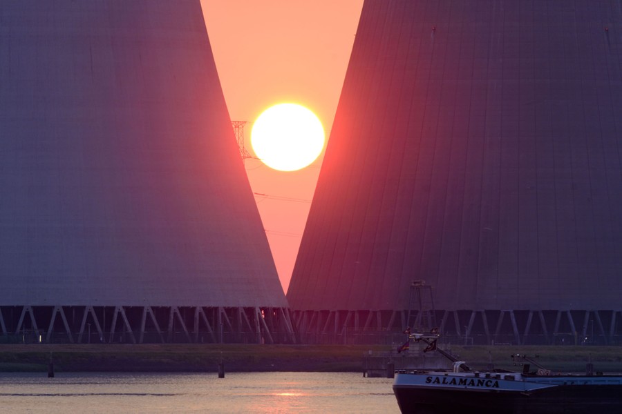 The sun sets between two cooling towers of a nuclear-power station.