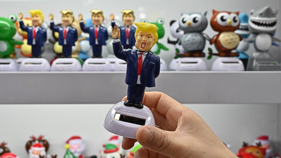Hand holding a Donald Trump toy