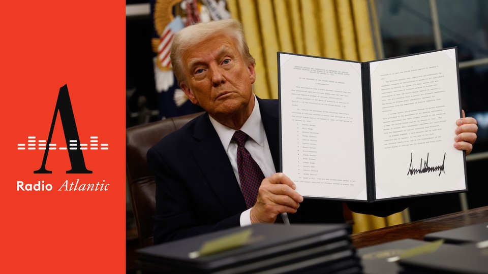 President Donald Trump holds up an executive order that gave sweeping pardons for more than 1,500 January 6 defendants.