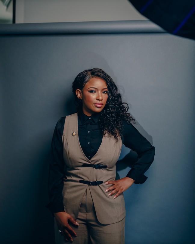 Jasmine Crockett stands in front of a gray backdrop.