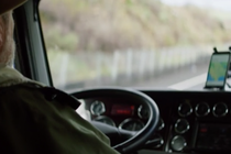 A view from behind of a person driving a truck