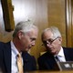 Senators Ron Johnson of Wisconsin (left) and Bob Corker of Tennessee talk at a committee hearing.