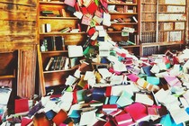 Wooden bookshelves linked with several books, giving way to a multicolored book avalanche