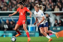 An American player chases a Portugese player at the Women's World Cup.