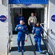 NASA astronauts Barry "Butch" Wilmore and Sunita "Suni" Williams walk out of a NASA building in their blue Boeing spacesuits