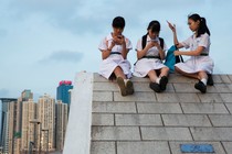 Photograph of young girls in China using their smartphones