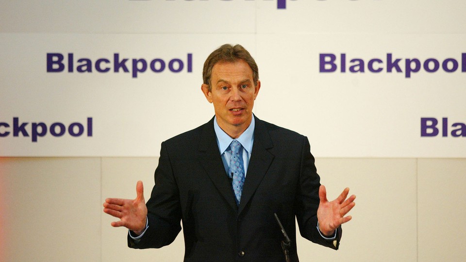 Tony Blair speaks at a podium at the Imperial Hotel in Blackpool.