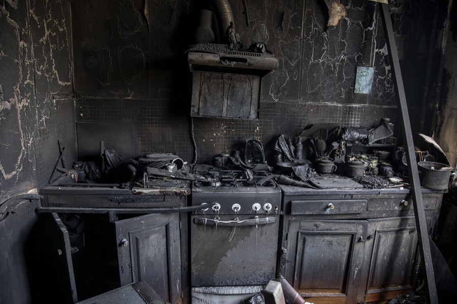 A kitchen completely scorched by a fire.