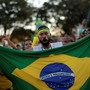 A protester holding a Brazilian flag