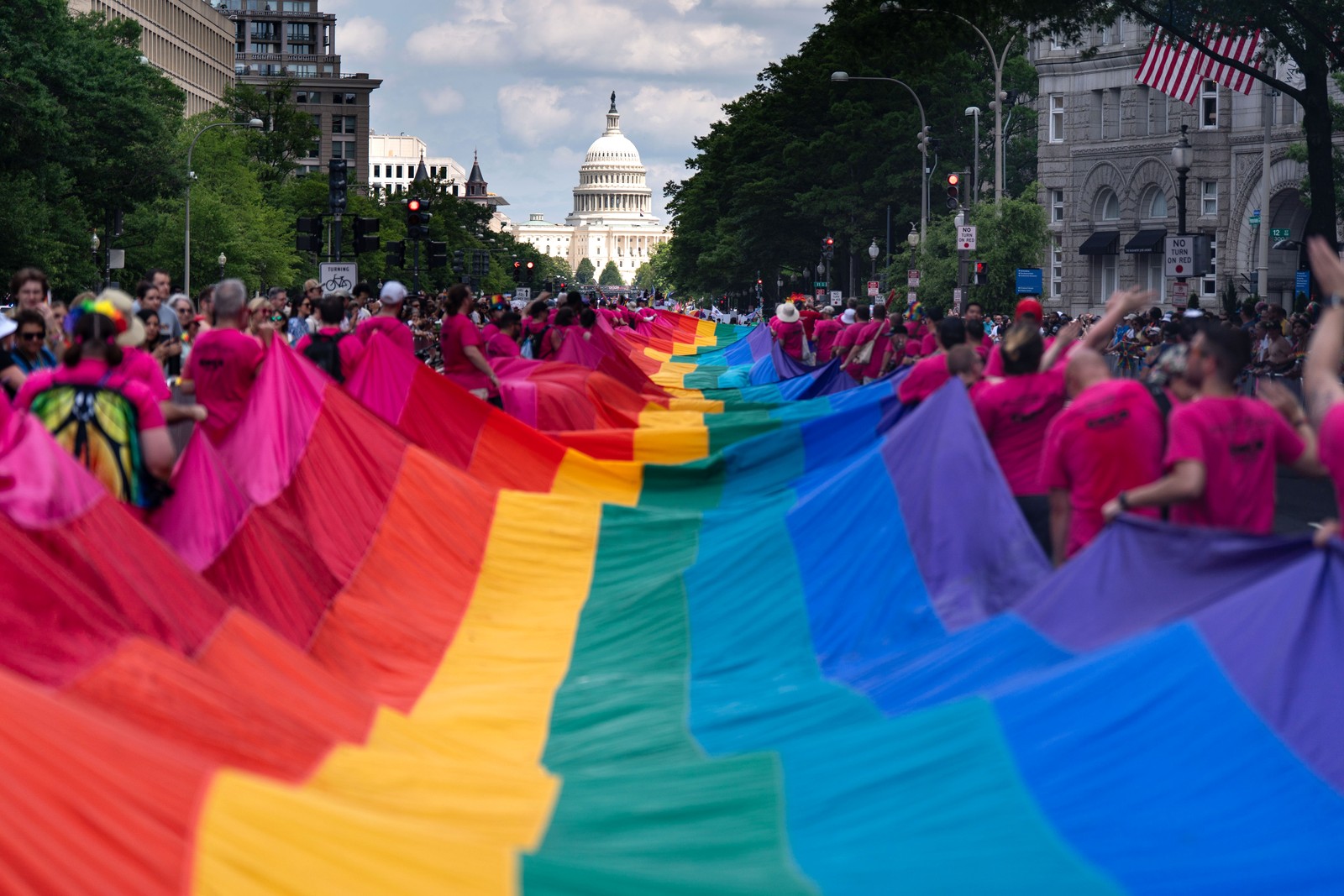 People carry a 1,000-foot rainbow flag along a parade route in Washington, D.C.