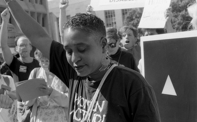 ACT UP activist is protesting with others.