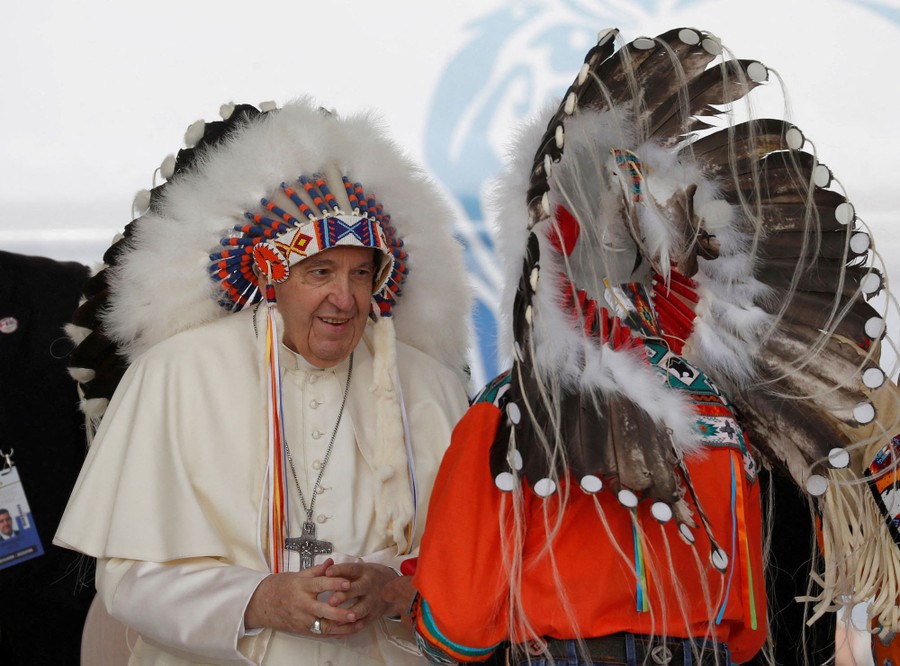 Pope Francis wears a feathered Indigenous headdress.