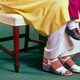 An image of a mother in high heels holding her son