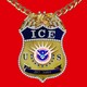 A bejeweled ICE badge on a gold chain
