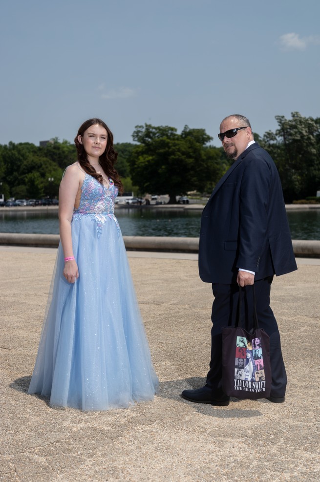 A father and daughter pose on the mall