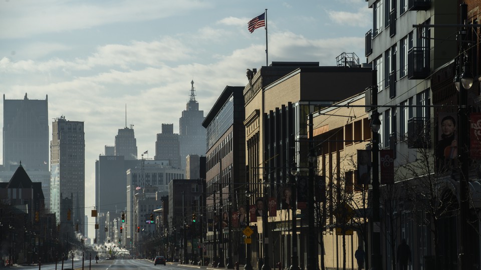 People walking along a deserted street in Detroit, Michigan