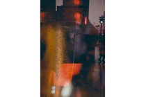 A blurry shot of New York in the rain and a black umbrella, through a rainy fog