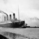 A black-and-white photograph depicting the Titanic departing for a sea trial