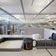A mug sits on a desk in an office. The mug reads "We can't spell success without U."