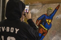 Artist takes photo of image of Donald Trump in Superman costume