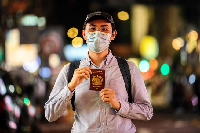 A Hong Kong man poses with his UK passport.