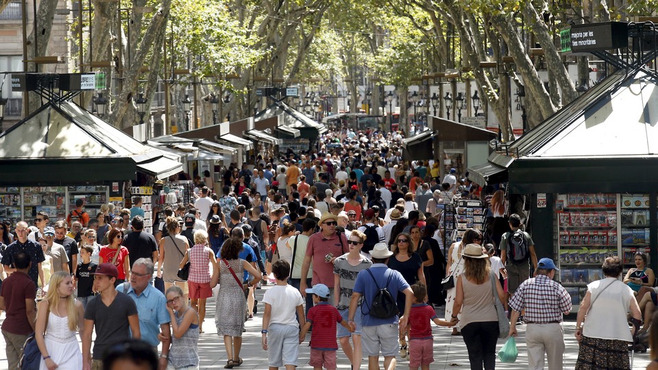 A crowd of people walks in Las Ramblas in Barcelona 