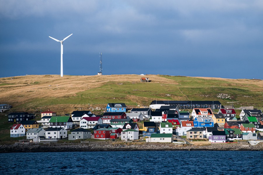 The buildings and houses of a coastal village, seen from the sea.
