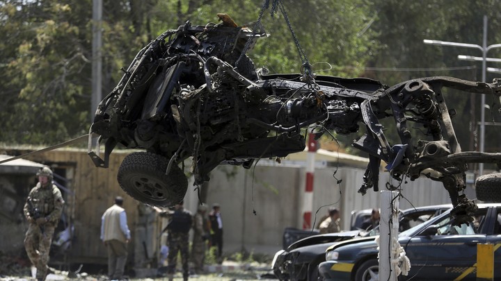 U.S. soldiers lift car wreckage with a crane in Kabul, Afghanistan.