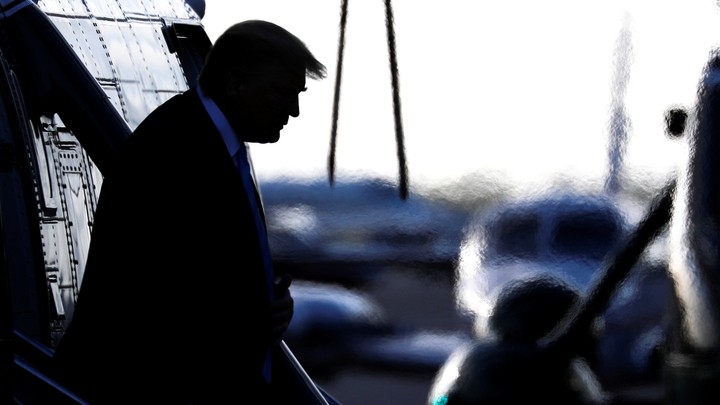 Donald Trump walks down the steps of Marine One.