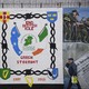 A man walks past a political mural in the Falls Road area of west Belfast, Northern Ireland, on February 28, 2017.