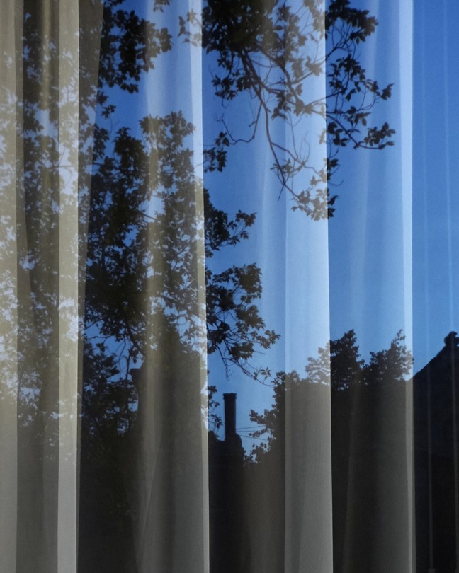 a sheer curtain with a blue night seen through it