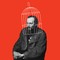 Black-and-white image of Dostoyevsky sitting with clasped hands with illustrated white cage over his head on red background