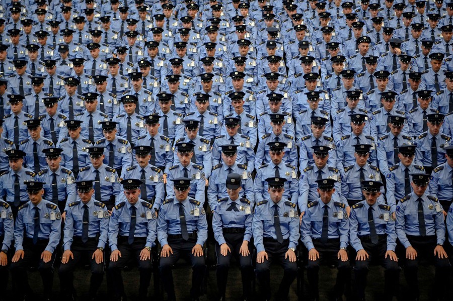 Rows of police officers sit together during a graduation ceremony.