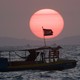 A fishing boat near Sihanoukville flies the Cambodian flag.