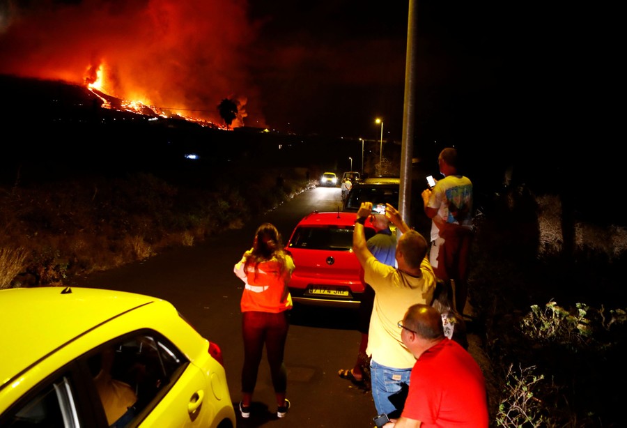 Residents watch lava flow at night.