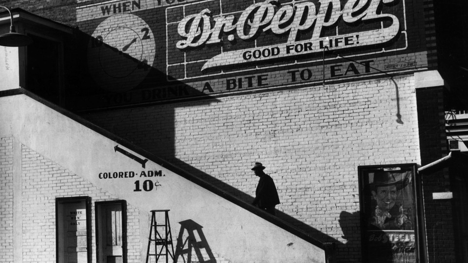 Man climbs stairs leading to segregated cinema.