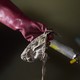 A gloved hand holding a wet wipe found in the Northern Outfall Sewer, London