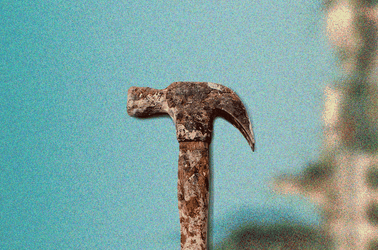 A hammer against a blurred landscape background
